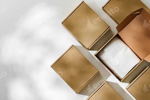 Preview: Brown cardboard boxes arranged on a neutral background in a warehouse setting during daylight hours