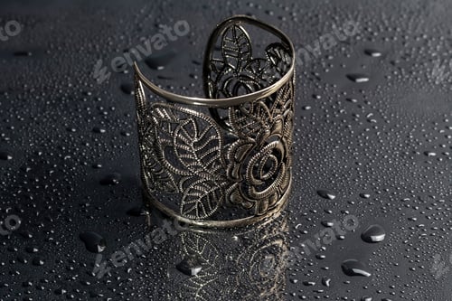 Preview: Bracelets. Women's jewelry on a dark background. Metal products. Fashion.