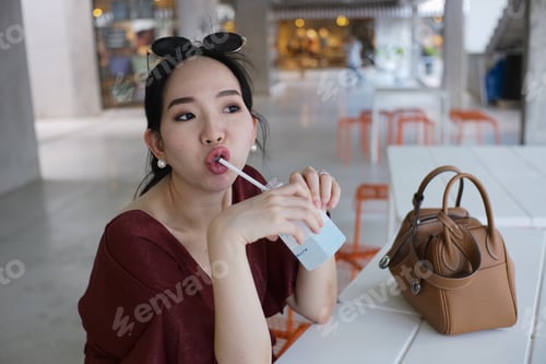 Woman Enjoys Drink at an Outdoor Cafe
