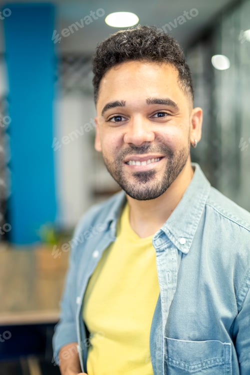 Preview: portrait of young latin man smiling indoors