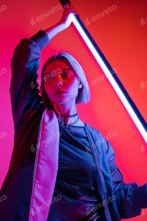 Preview: Stylish Woman Posing with Neon Light in Studio