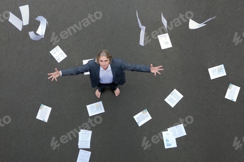 Preview: Papers falling on businessman standing on tarnac