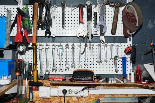 Preview: Assorted Hand Tools Hanging on Workshop Pegboard in Organized Arrangement