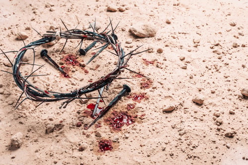 Preview: Crown of thorns, bloody nails on sand background. Good Friday, Passion of Jesus Christ. Christian