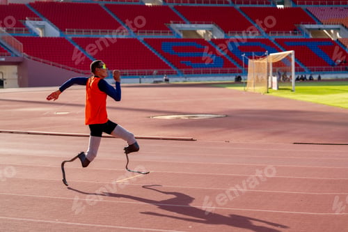 Preview: Asian para-athletes with prosthetic blades sprint on a running track at stadium.