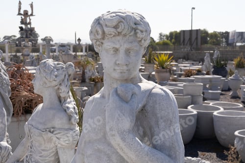 Preview: Ancient stone sculpture of man in reclamation yard