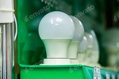 Preview: LED energy saving light bulb on green background.