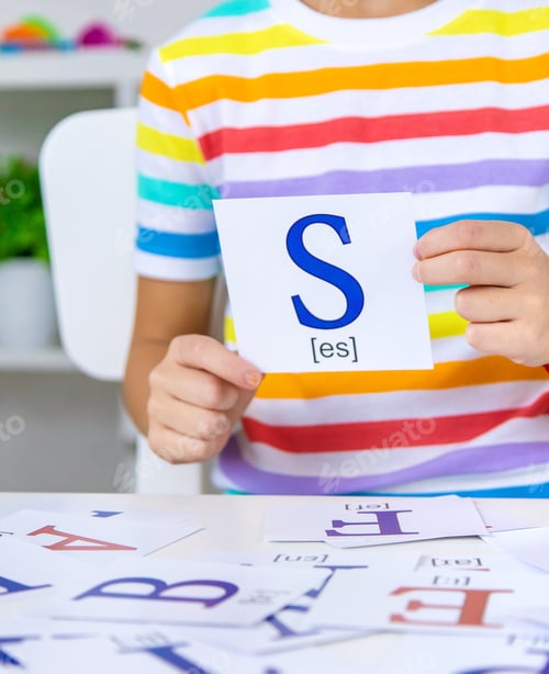 Preview: The child learns English letters. Selective focus.