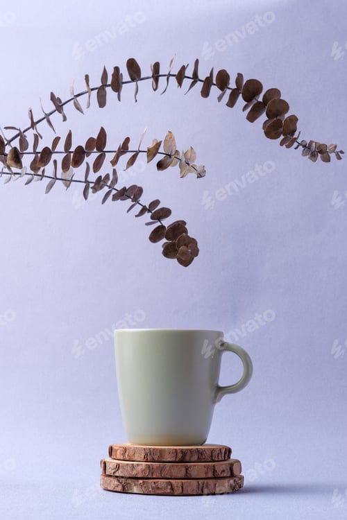 Preview: green coffee cup with eucalyptus leaves on pastel violet background