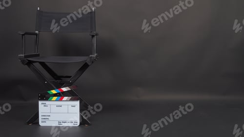 Preview: Black director chair and Clapperboard on black background.