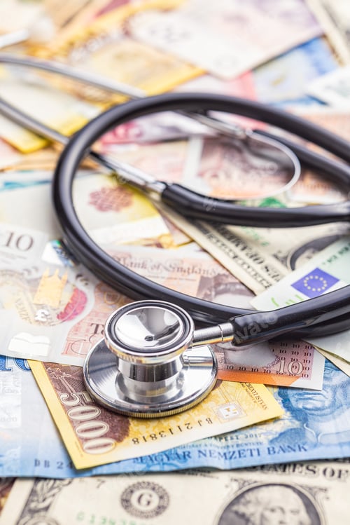 Preview: Stethoscope on various banknotes background.