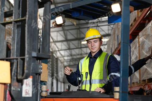 Preview: Warehouse workers working in the large logistic distribution warehouse. Workers in reflective cloth