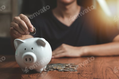 Preview: Man Saving Money in Piggy Bank Indoors