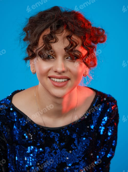 Preview: Close-up portrait of young curly-haired lady smiling to the camera