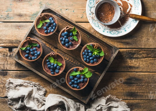 Preview: Homemade Tiramisu dessert and sieve with cocoa powder in tray