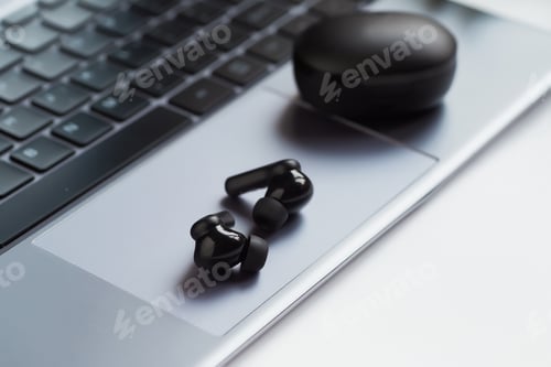 Preview: Wireless headphones on the laptop.