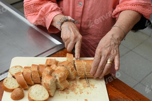 Preview: Woman's hands hold French bread .Woman cuts bread, bread with a crispy crust is beautiful
