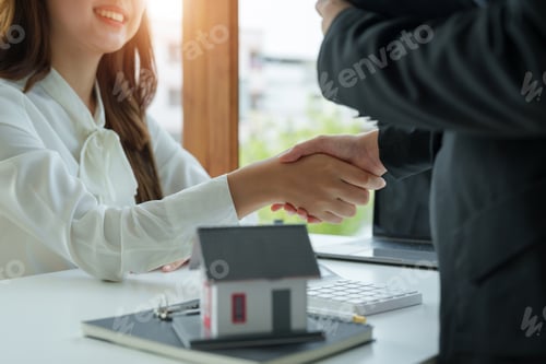 Preview: Estate agent and customer shaking hands after finished contract after about home insurance and