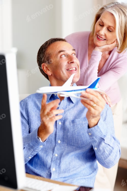 Preview: Couple in front of computer with a man holding toy airplane