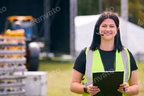 Preview: Portrait Of Female Production Worker Setting Up Outdoor Stage For Music Festival Or Concert