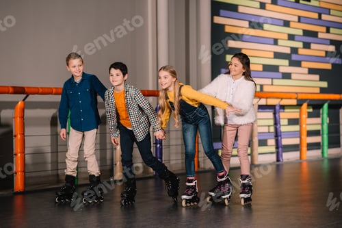 Preview: Full length shot of kids fooling around on skating rink