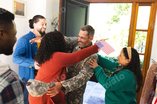 Preview: Happy diverse friends with flags welcoming home male soldier friend