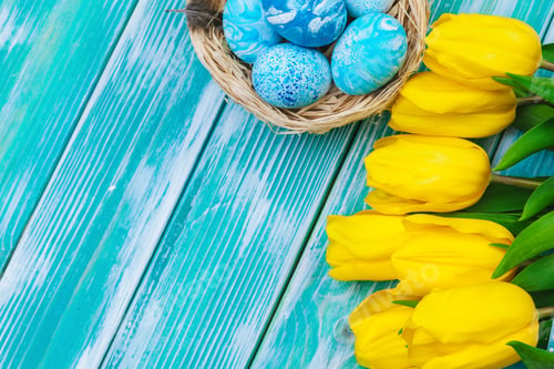 Preview: Easter eggs and tulips. Festive decoration on wood background. Holiday card with copy space