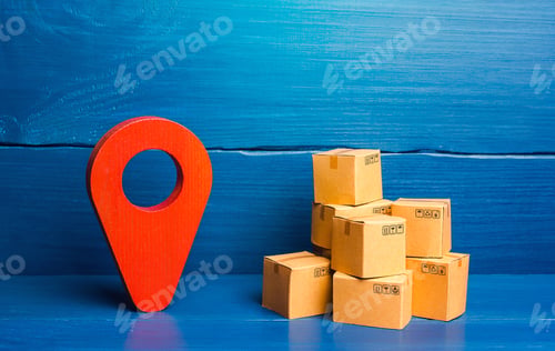 Preview: Red location pin pointer symbol and cardboard boxes.