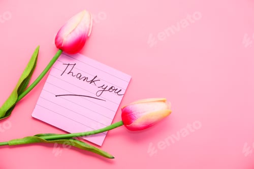 Preview: thank you message on sticky note with tulip flower on pink background