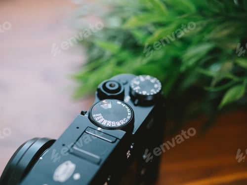 Preview: High angle closeup of the mode dial of a camera on the table under the lights