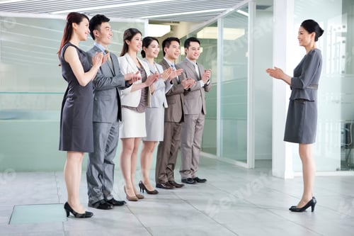 Preview: Cheerful businesspeople applauding in a meeting