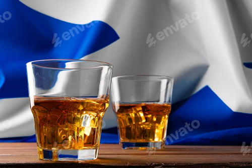 Preview: Glass of Scottish whisky against national flag of Scotland