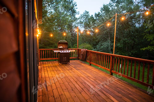 Preview: Wooden porch with string lights and grill