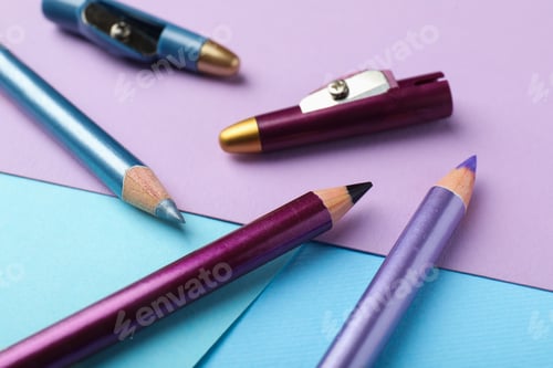 Preview: Colorful eye pencils with sharpeners on color background, closeup