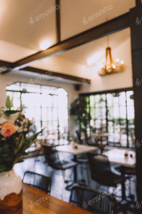 Preview: A soft focus on a cafe interior, highlighting warm lighting.