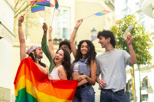 Preview: Young activists waving rainbow flags at pride parade celebrating lgbtq plus community