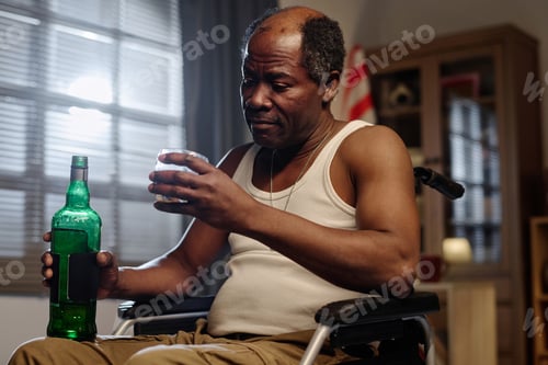 Preview: Depressed Black Man in Wheelchair Drinking Large Amounts of Alcohol
