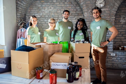 Preview: Portrait of volunteers with working in community charity donation center.
