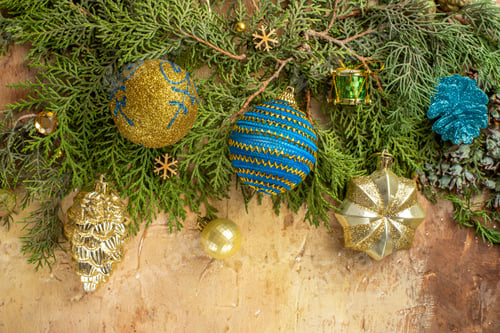 Preview: top view fir branches xmas tree ornaments on beige background