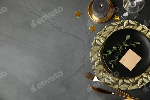 Preview: Elegant festive table setting with blank card on dark grey background, flat lay. Space for text