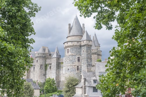 Preview: Chateau de Vitre surrounded by greenery under a cloudy sky in France
