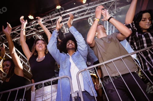 Preview: Low angle view of crowd enjoying at nightclub