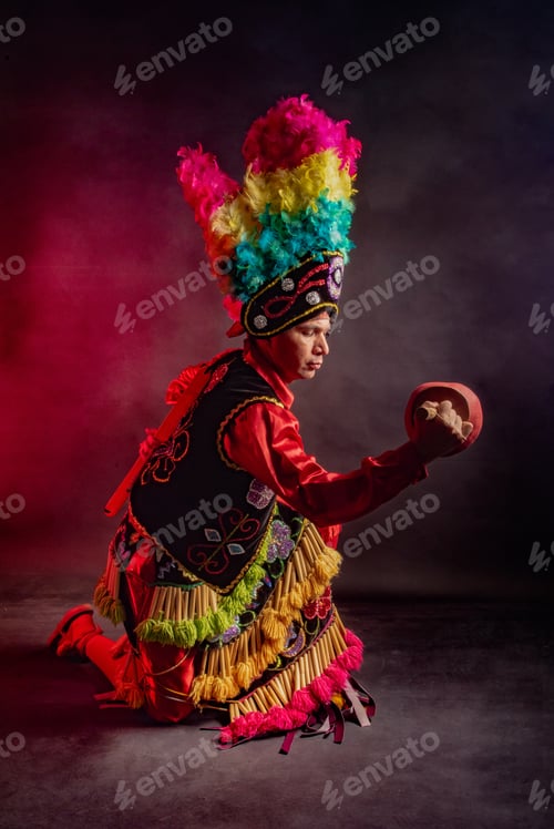 Preview: Matlachines Dancer from Coahuila Mexico A man wearing a colorful costume and holding a drum