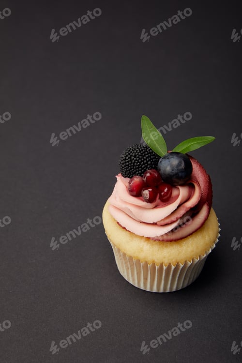 Preview: Delicious Cupcake with Frosting and Berries on Top