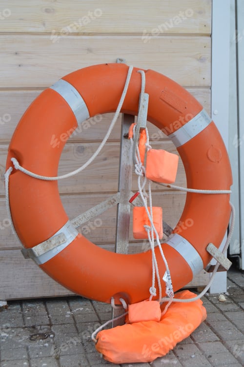 Preview: Old lifebuoy on the beach, rescue symbol, help