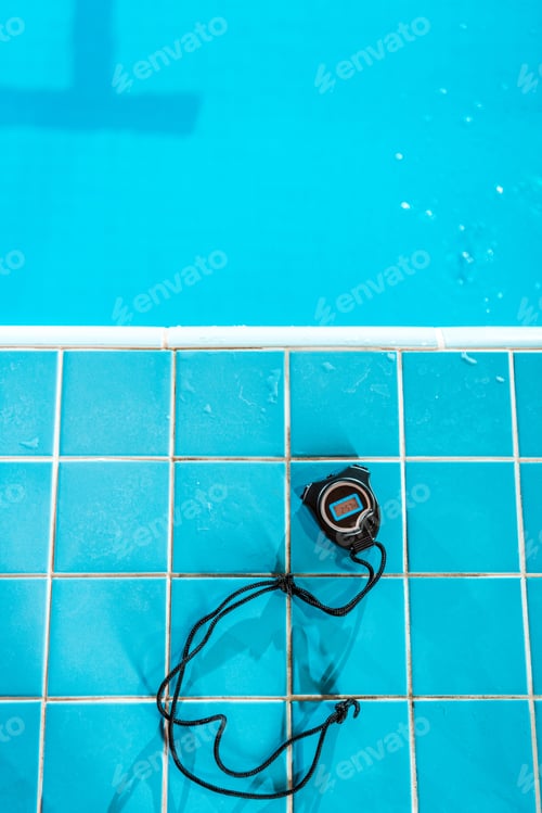 Preview: top view of stopwatch lying at competition swimming pool