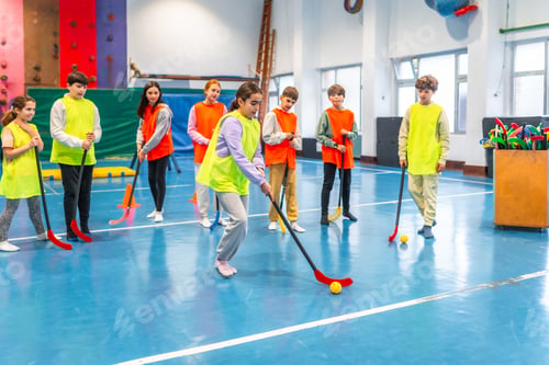Preview: Students playing floorball in gym class at school
