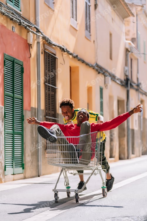 Preview: Overjoyed young black teenagers having fun in street
