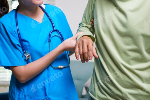Preview: Elderly patient on sofa trying to stand and walking with caregiver nurse