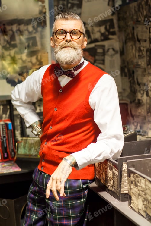 Preview: Portrait of quirky vintage senior man in vintage record shop